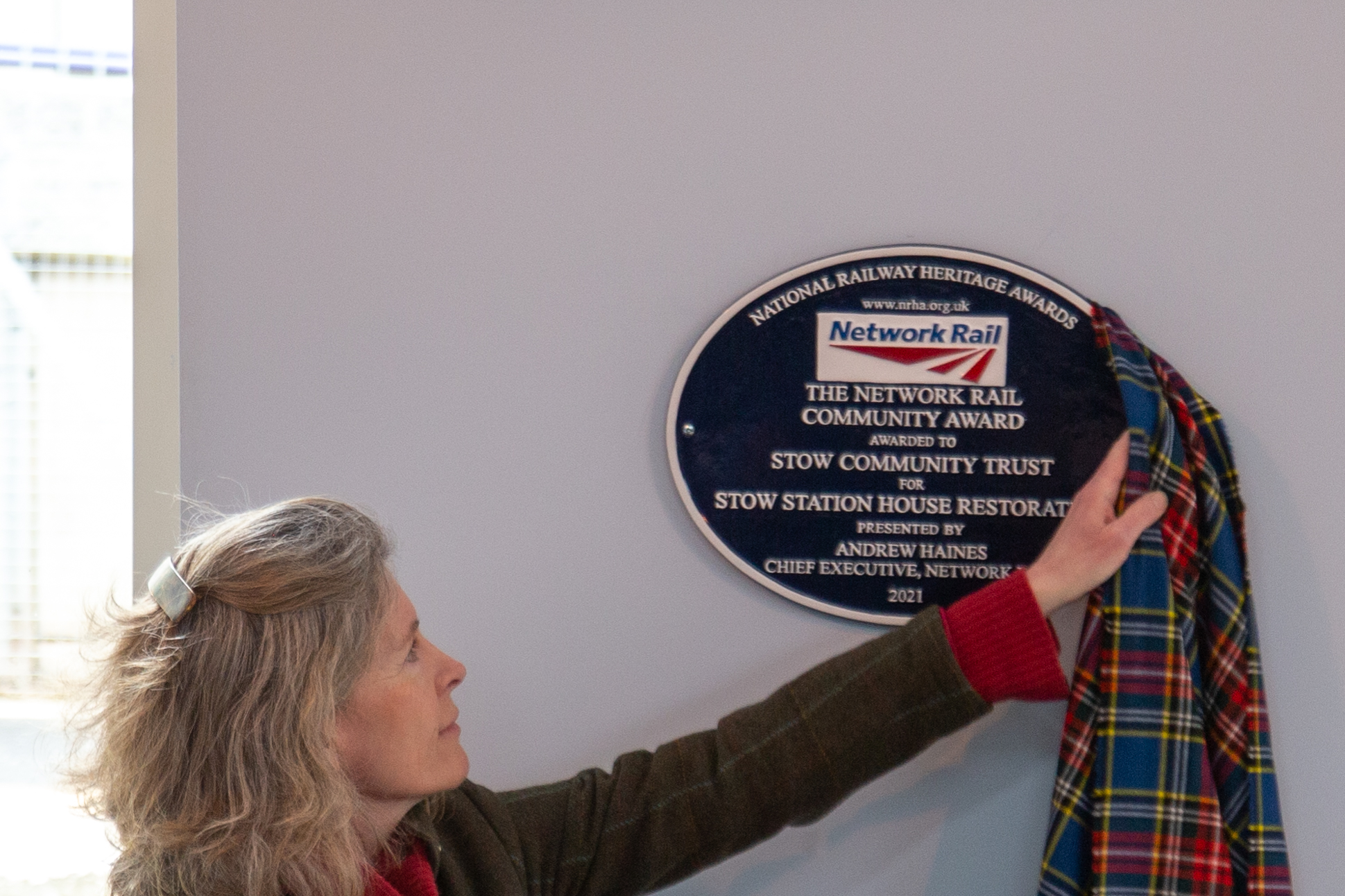 Jo Noble of Network Rail unveiling Network Rail Community Award plaque